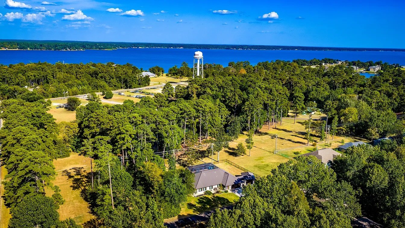 Aerial view of the home with Lake Livingston beyond
