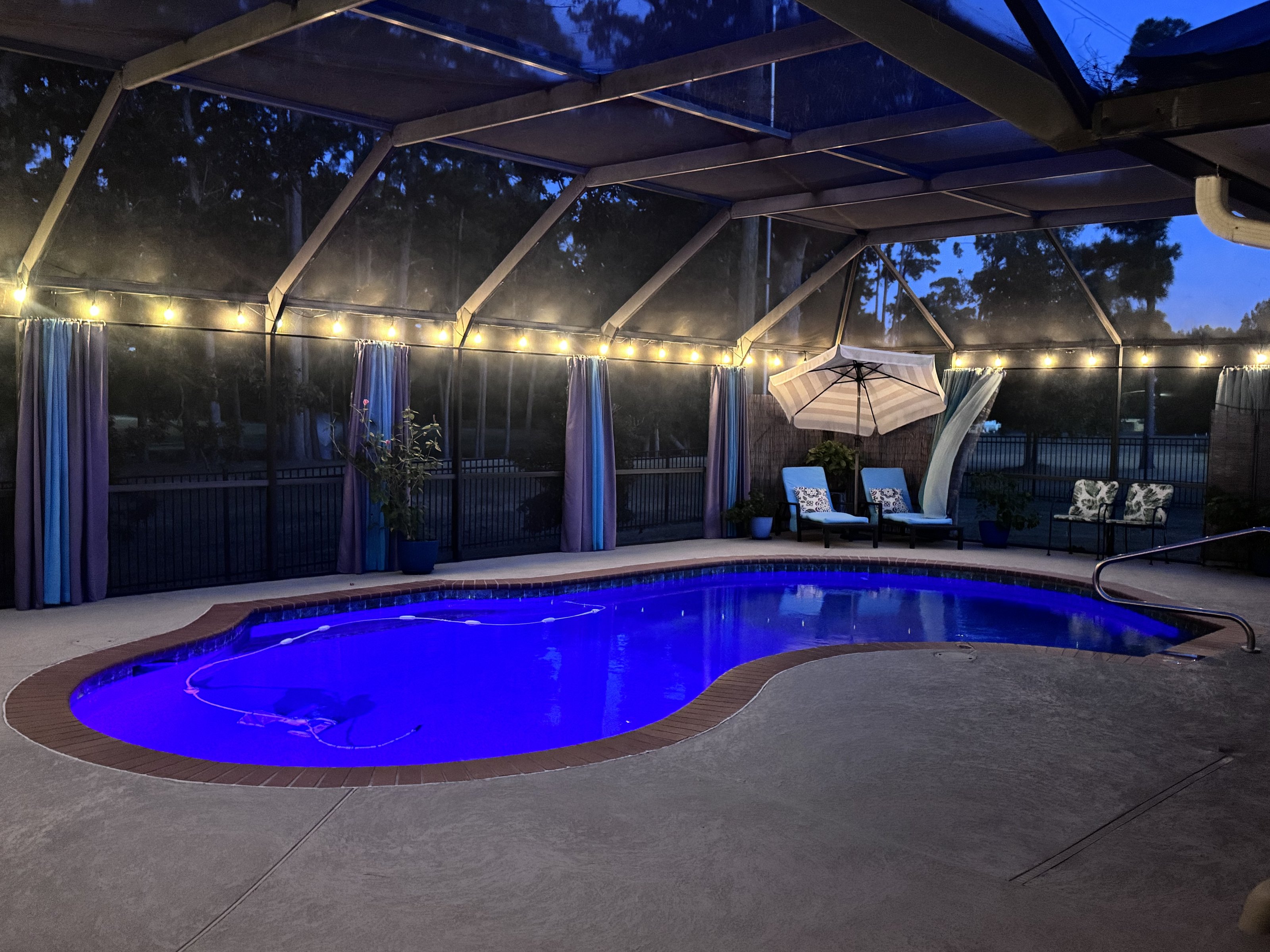 Screened pool lit at night